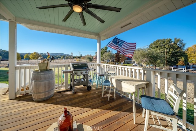 deck featuring a mountain view, area for grilling, and ceiling fan