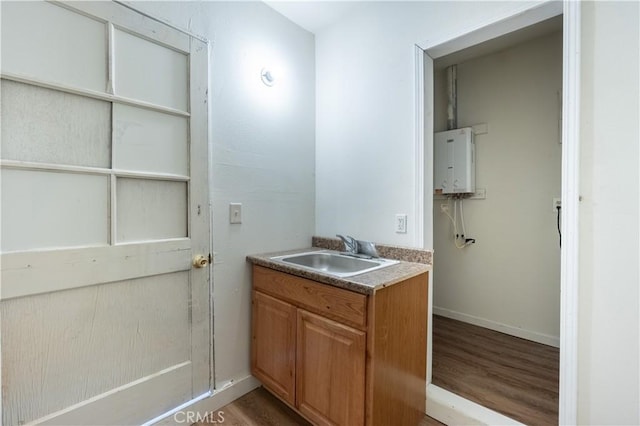 50471 Cholla Rd, Johnson Valley, CA 92285 - bathroom with baseboards, wood finished floors, water heater, and vanity