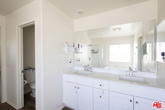 full bathroom featuring toilet, hardwood / wood-style floors, vanity, and separate shower and tub