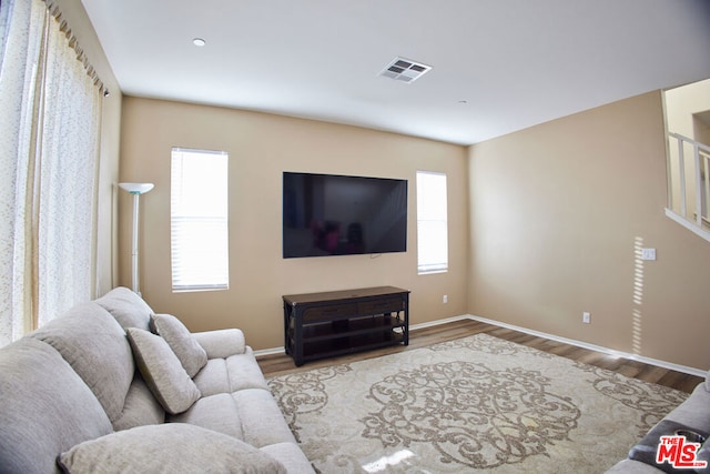 living room with hardwood / wood-style floors and a healthy amount of sunlight