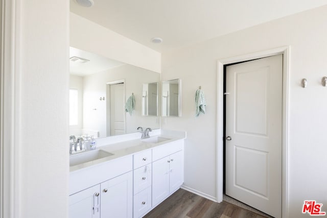 bathroom with vanity and hardwood / wood-style flooring