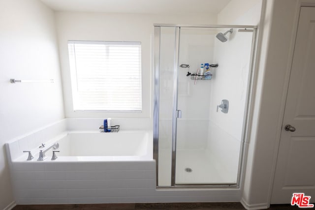 bathroom featuring independent shower and bath