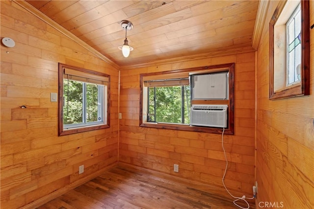 empty room featuring lofted ceiling, wood-type flooring, wooden walls, cooling unit, and wood ceiling