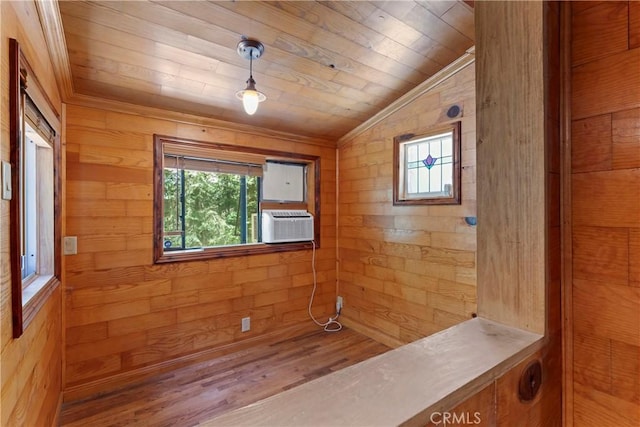 interior space with cooling unit, vaulted ceiling, wood walls, and wooden ceiling