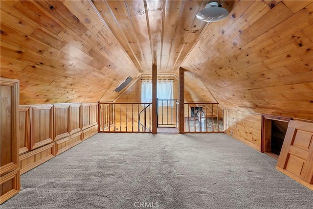 bonus room with carpet floors, wooden ceiling, lofted ceiling, and wood walls