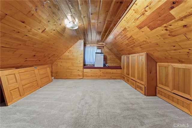 additional living space featuring light carpet, lofted ceiling, wood walls, and wood ceiling