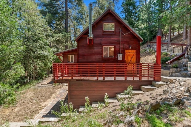 back of property featuring a wooden deck