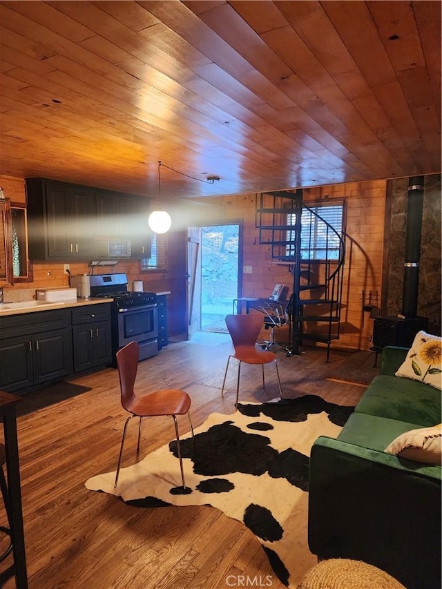 living room with wooden ceiling, light hardwood / wood-style floors, and sink