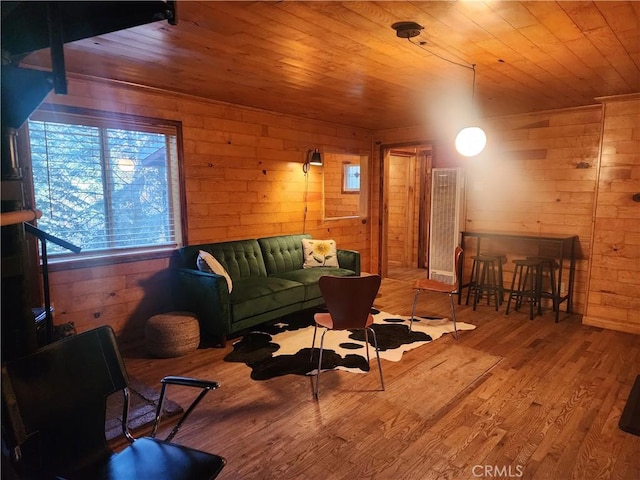 living room featuring hardwood / wood-style flooring, wood walls, and wooden ceiling