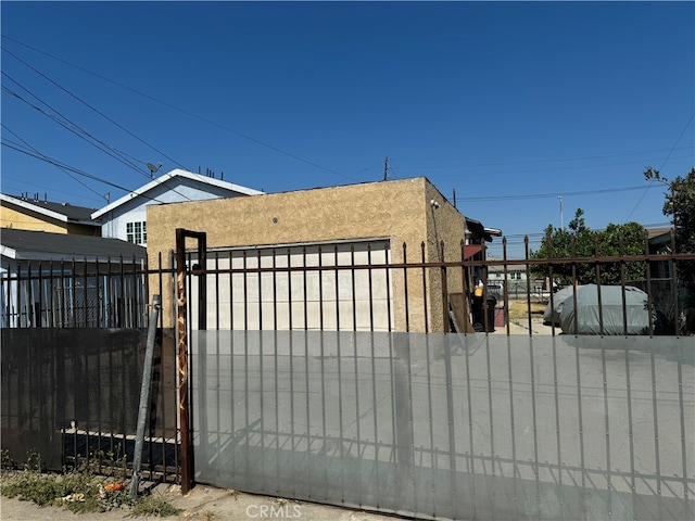 view of gate with a garage