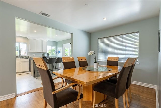 dining space featuring light wood-type flooring