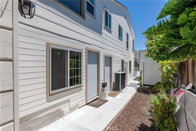 view of property exterior with a patio area and cooling unit