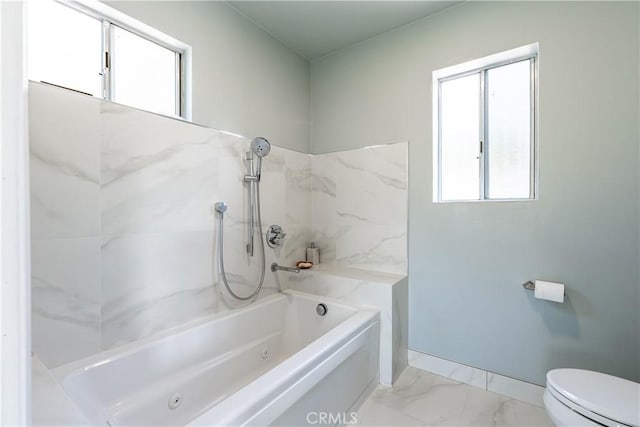 bathroom featuring toilet and a tub