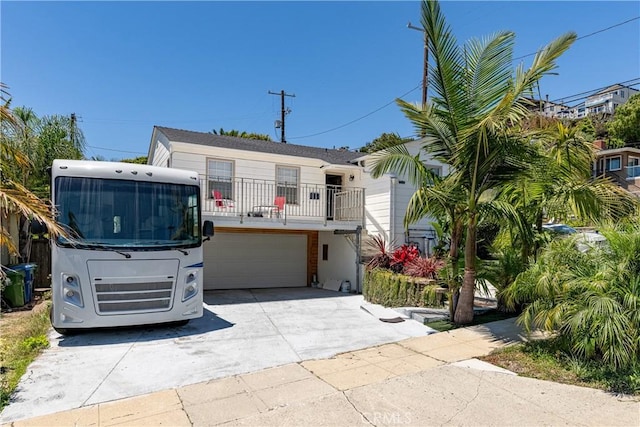 view of front of house featuring a balcony and a garage