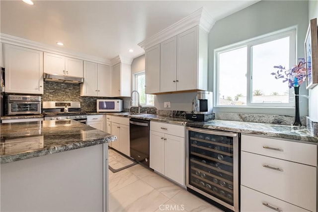 kitchen featuring black dishwasher, beverage cooler, stainless steel range oven, white cabinets, and sink