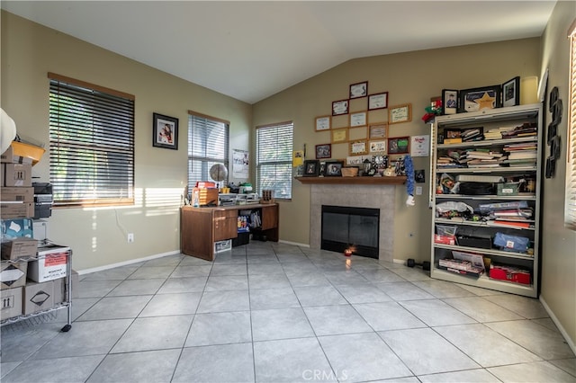 tiled home office featuring a fireplace and vaulted ceiling