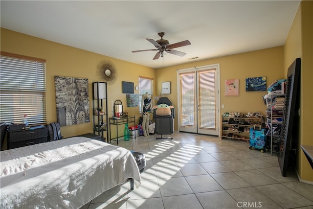 tiled bedroom with ceiling fan