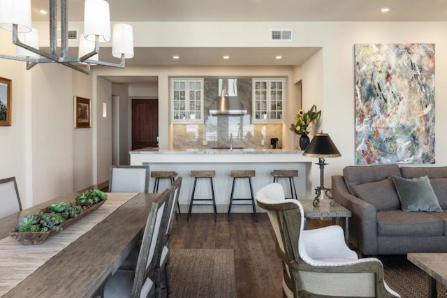 interior space featuring dark hardwood / wood-style flooring, an inviting chandelier, and sink