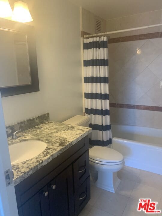 full bathroom with tile patterned flooring, vanity, toilet, and shower / tub combo