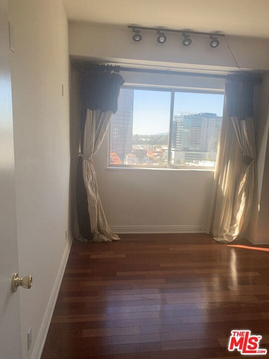 empty room with dark wood-type flooring