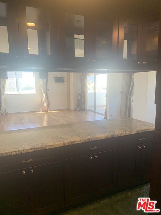 kitchen with light stone countertops and a wealth of natural light