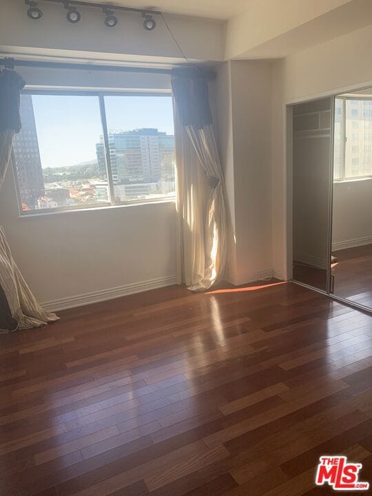 spare room featuring dark hardwood / wood-style floors