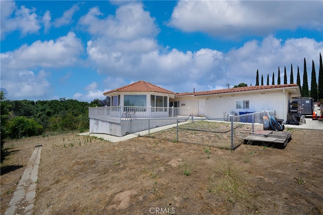 back of house featuring a sunroom