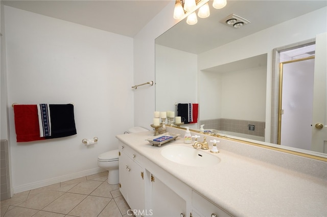 bathroom with vanity, toilet, tile patterned floors, and a bathing tub