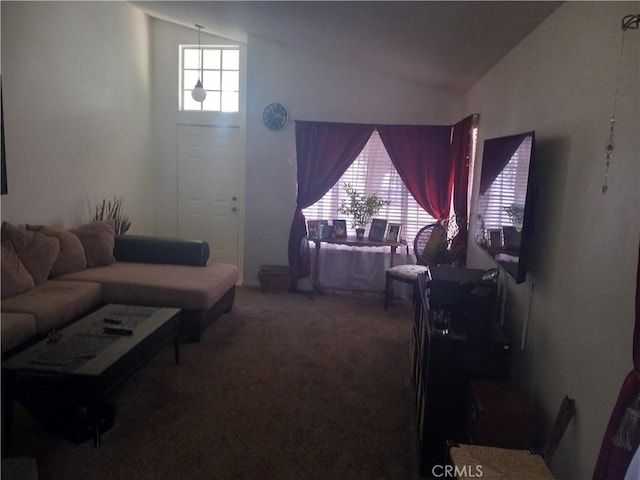 carpeted living room with vaulted ceiling