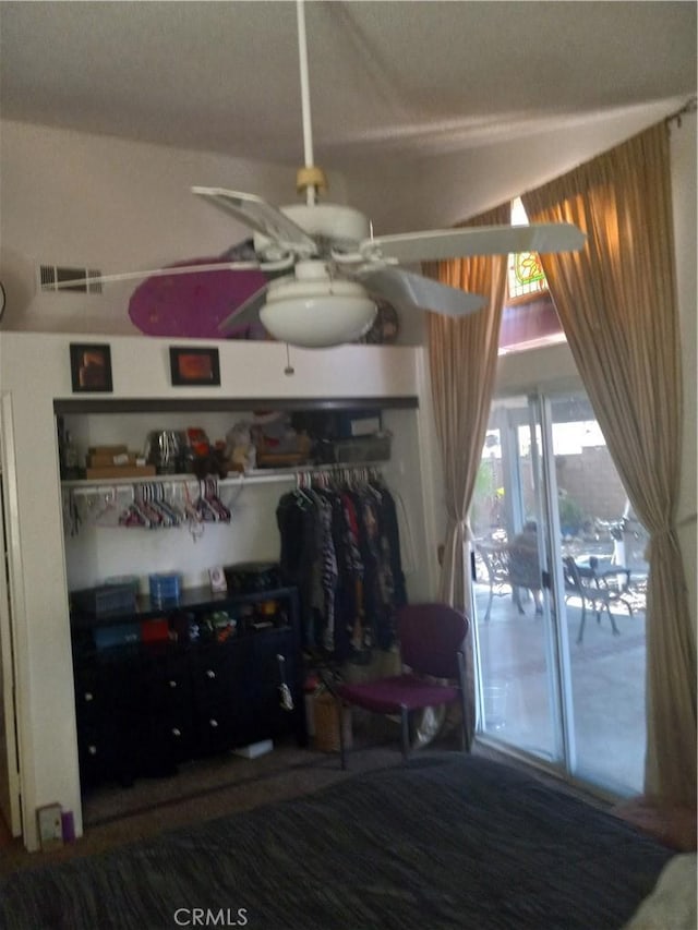 bedroom with ceiling fan and a closet