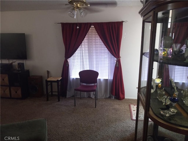 carpeted living room featuring ceiling fan