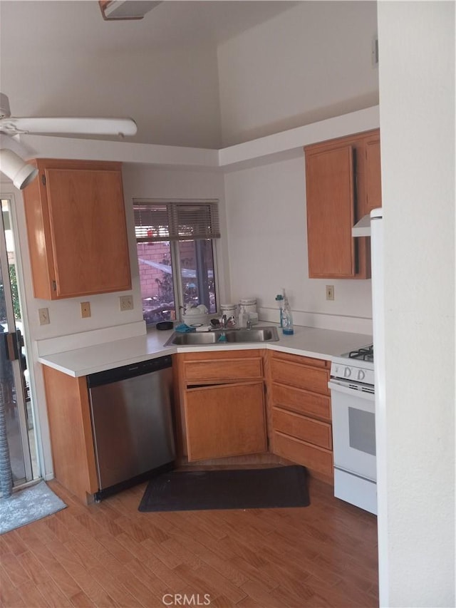 kitchen with dishwasher, sink, white gas range, ceiling fan, and light hardwood / wood-style flooring