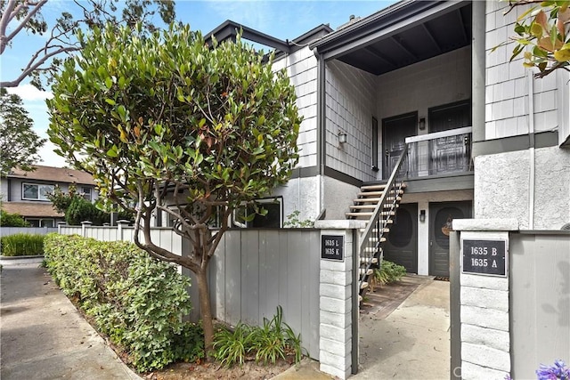 view of property with stairway and fence