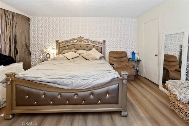 bedroom featuring a textured ceiling and hardwood / wood-style flooring