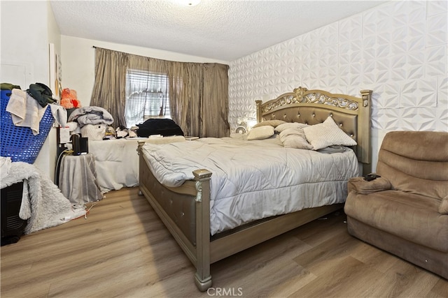 bedroom featuring a textured ceiling and hardwood / wood-style flooring