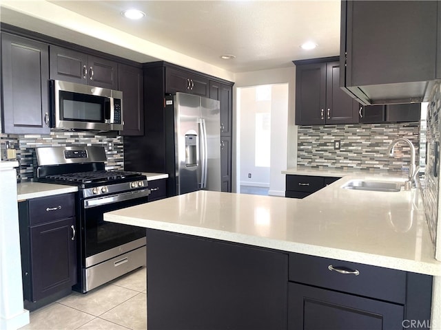 kitchen featuring decorative backsplash, stainless steel appliances, light tile patterned floors, and sink