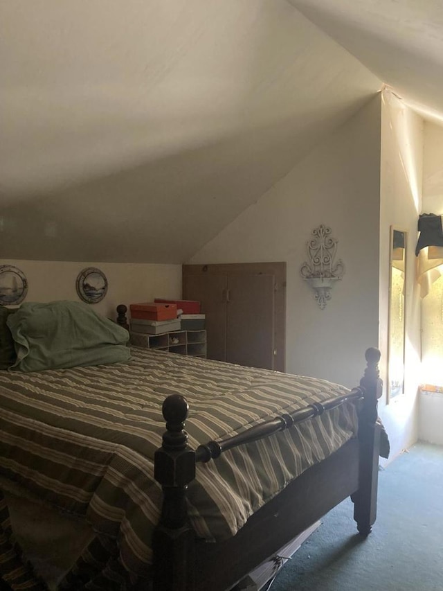 bedroom with carpet flooring and vaulted ceiling