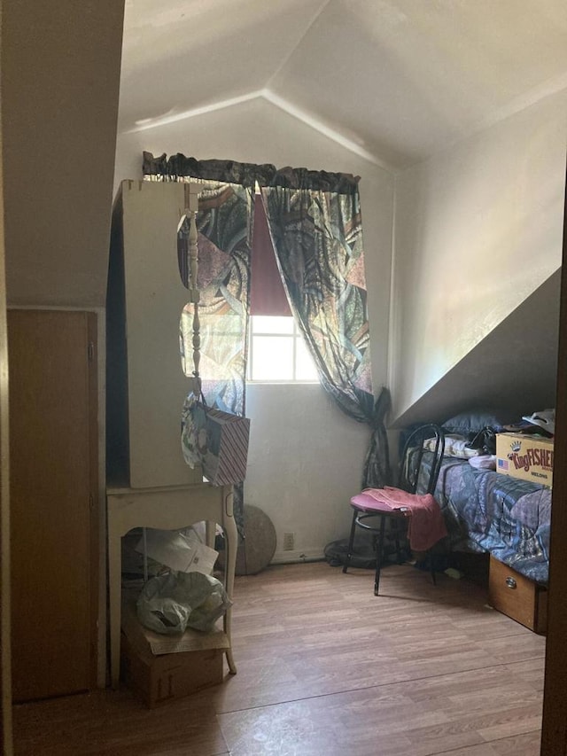 bedroom featuring vaulted ceiling and light hardwood / wood-style flooring