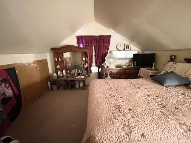 bedroom with carpet flooring and lofted ceiling