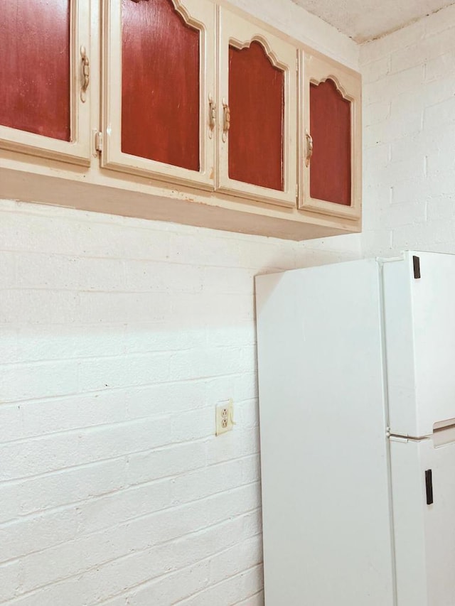 interior details with cream cabinets and white fridge