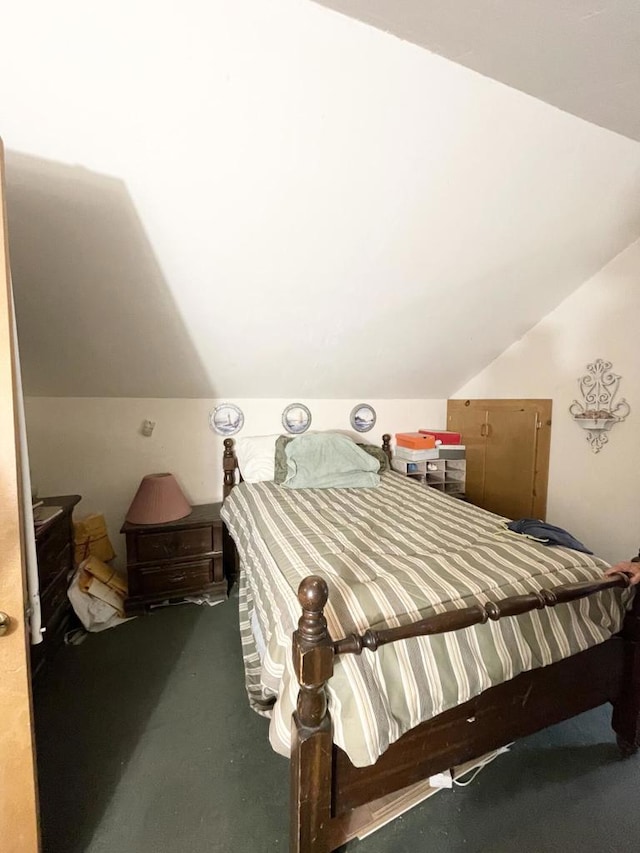 bedroom featuring carpet floors and vaulted ceiling