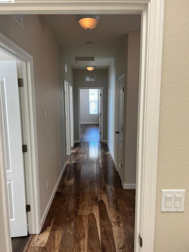 hallway with dark hardwood / wood-style flooring