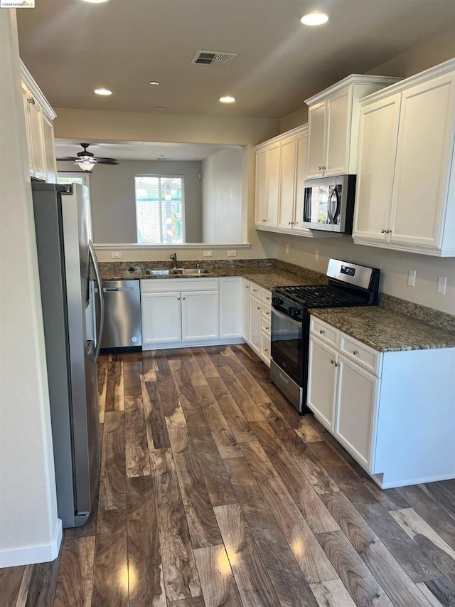 kitchen with sink, white cabinets, stainless steel appliances, dark hardwood / wood-style flooring, and ceiling fan