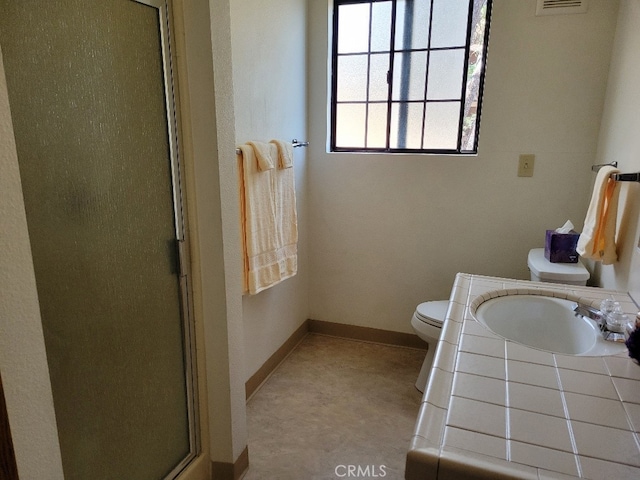 bathroom with vanity, toilet, and an enclosed shower