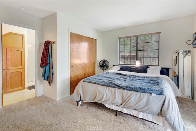 bedroom with light colored carpet and a closet