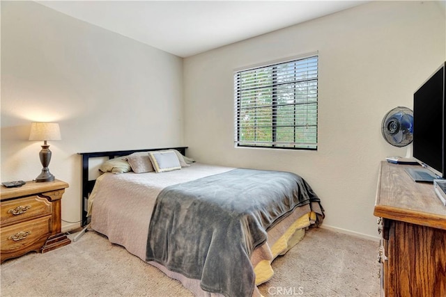 bedroom featuring light carpet