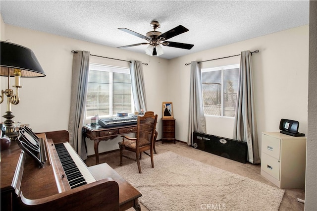 carpeted office with ceiling fan and a textured ceiling