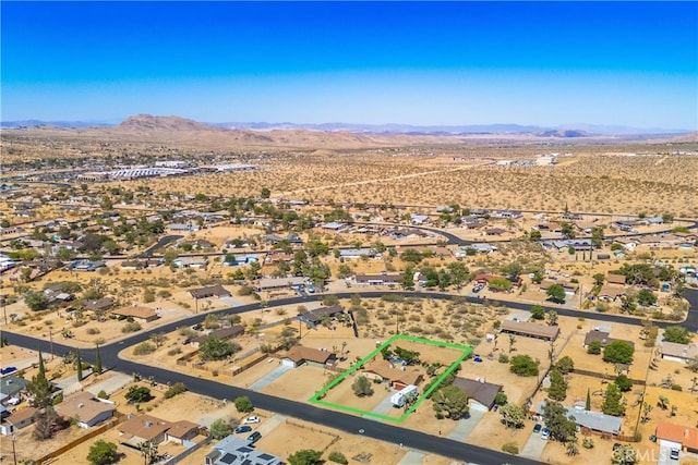 birds eye view of property with a mountain view