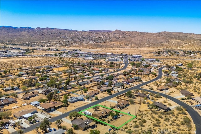 birds eye view of property with a mountain view