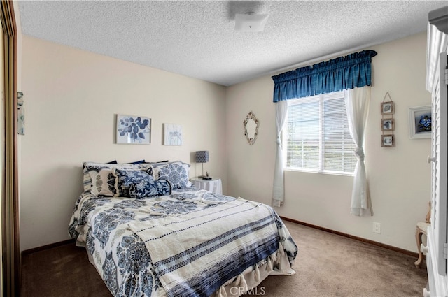 carpeted bedroom featuring a textured ceiling